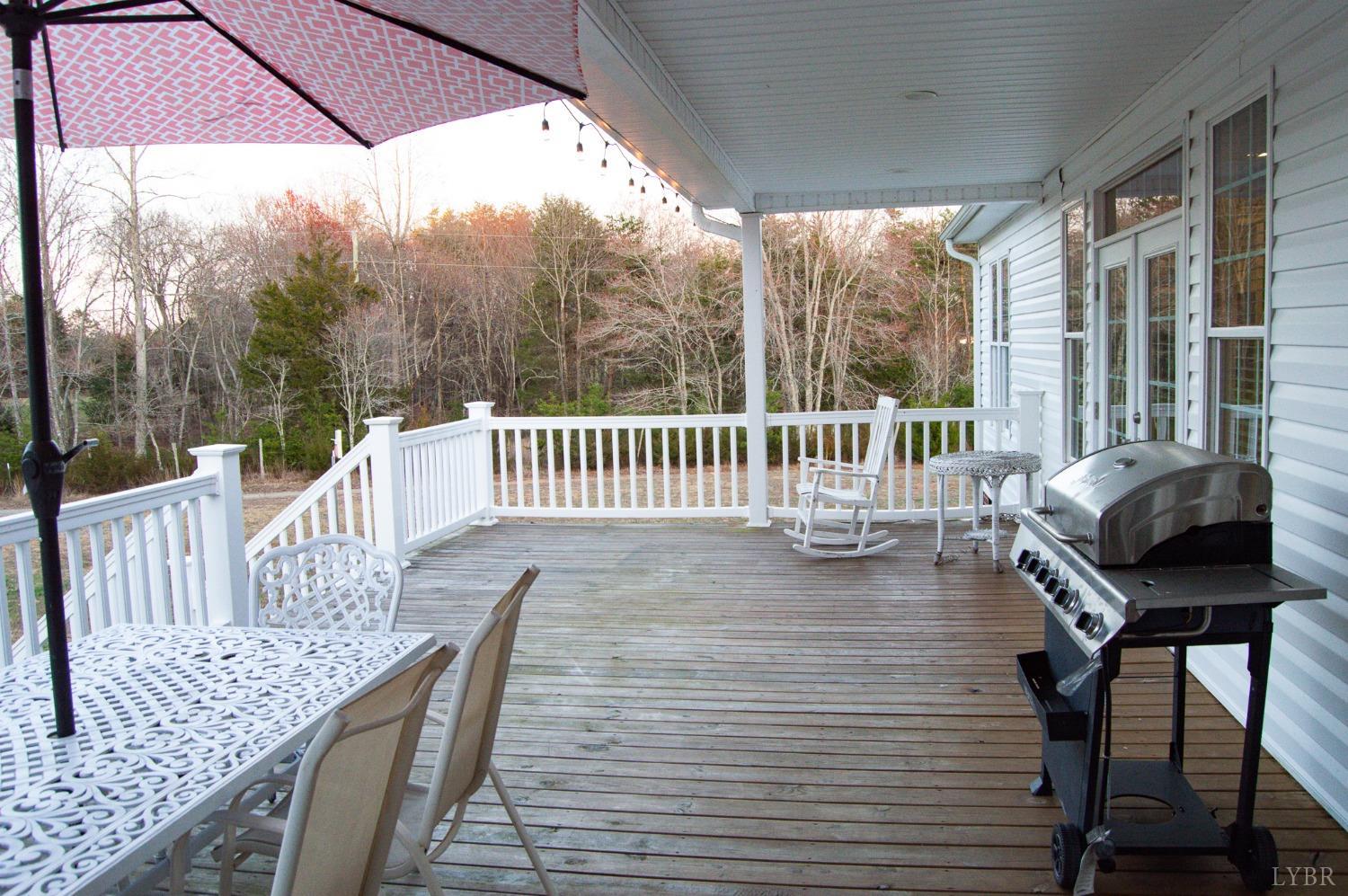 7108 Callands Road Chatham, VA 24531 - Photo 12 of 63 a view of a chair and table on the deck