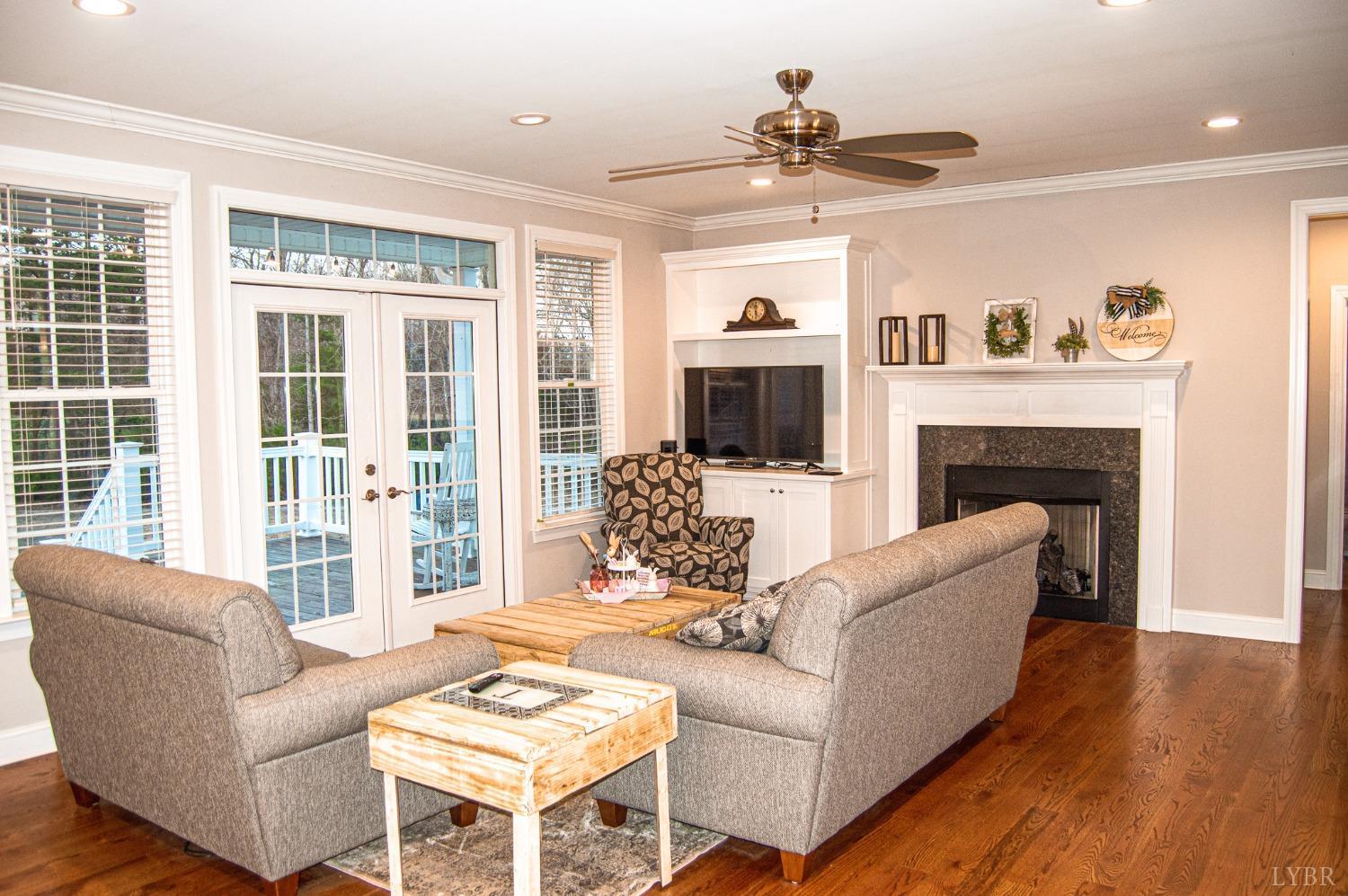 7108 Callands Road Chatham, VA 24531 - Photo 28 of 63 a living room with furniture a fireplace and a flat screen tv