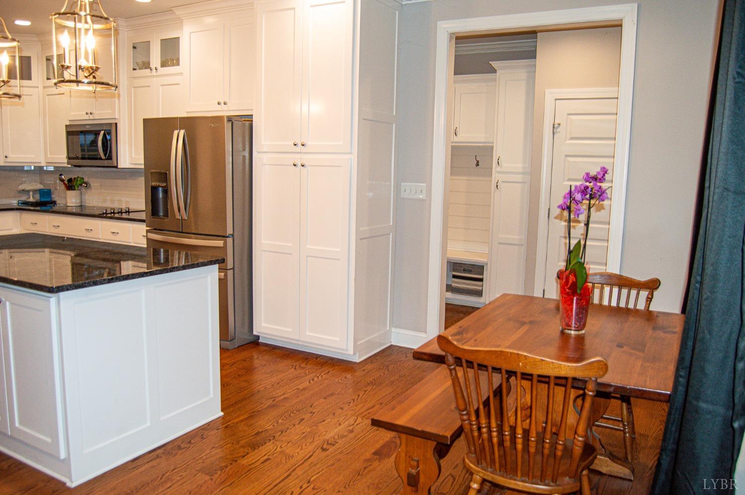 7108 Callands Road Chatham, VA 24531 - Photo 34 of 63 a kitchen with stainless steel appliances granite countertop a refrigerator a stove and a microwave with wooden floor