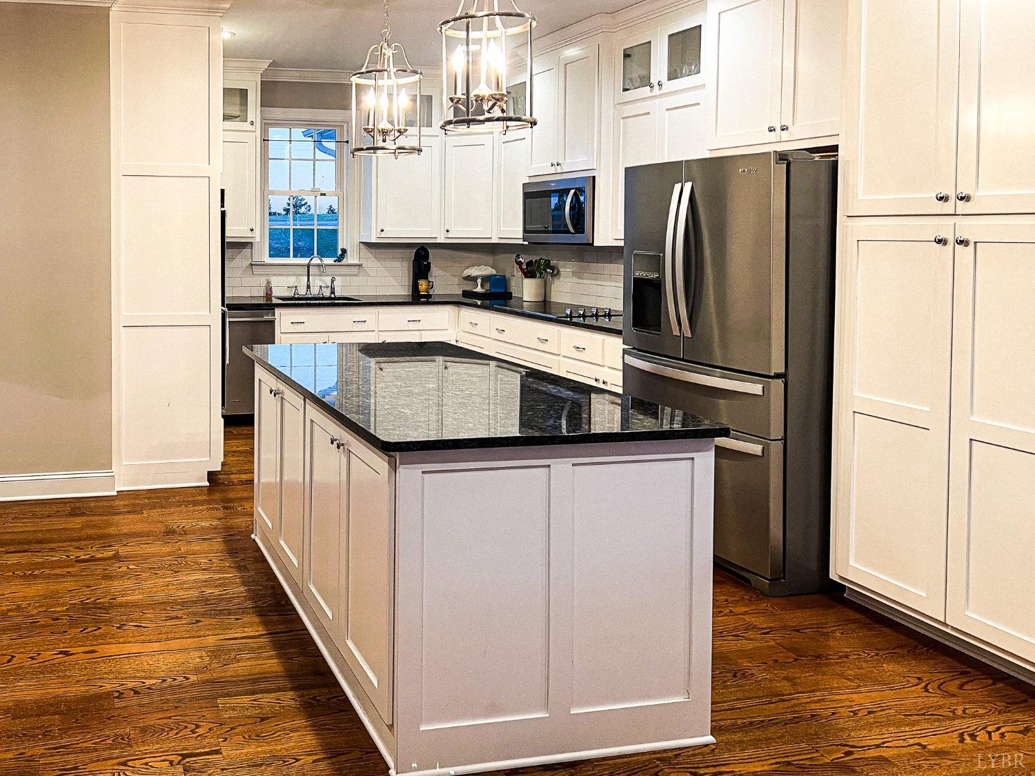 7108 Callands Road Chatham, VA 24531 - Photo 36 of 63 a kitchen with stainless steel appliances a refrigerator sink and cabinets