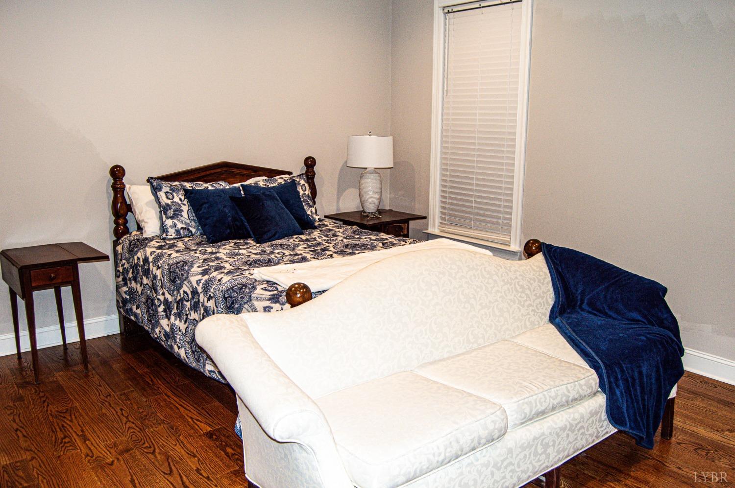 7108 Callands Road Chatham, VA 24531 - Photo 42 of 63 a bedroom with a bed and wooden floor