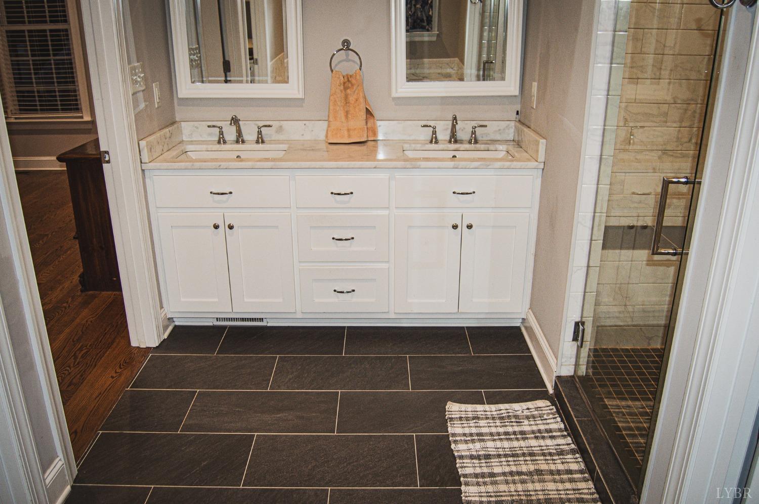 7108 Callands Road Chatham, VA 24531 - Photo 45 of 63 a bathroom with a sink a mirror and a shower