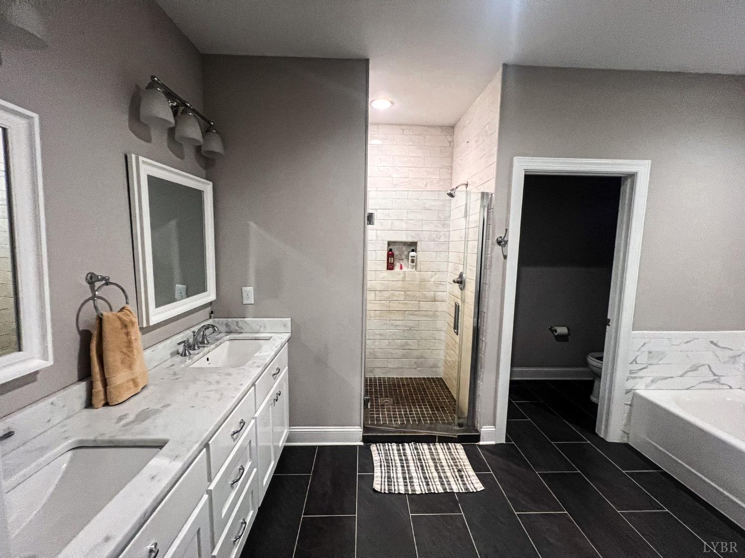 7108 Callands Road Chatham, VA 24531 - Photo 46 of 63 a bathroom with a double vanity sink and a mirror