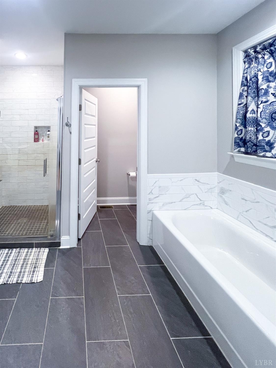 7108 Callands Road Chatham, VA 24531 - Photo 51 of 63 a spacious bathroom with a tub and shower