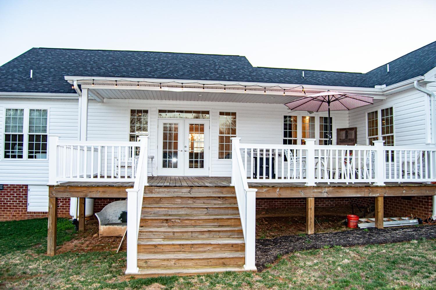 7108 Callands Road Chatham, VA 24531 - Photo 6 of 63 a view of a house with a small yard and wooden deck
