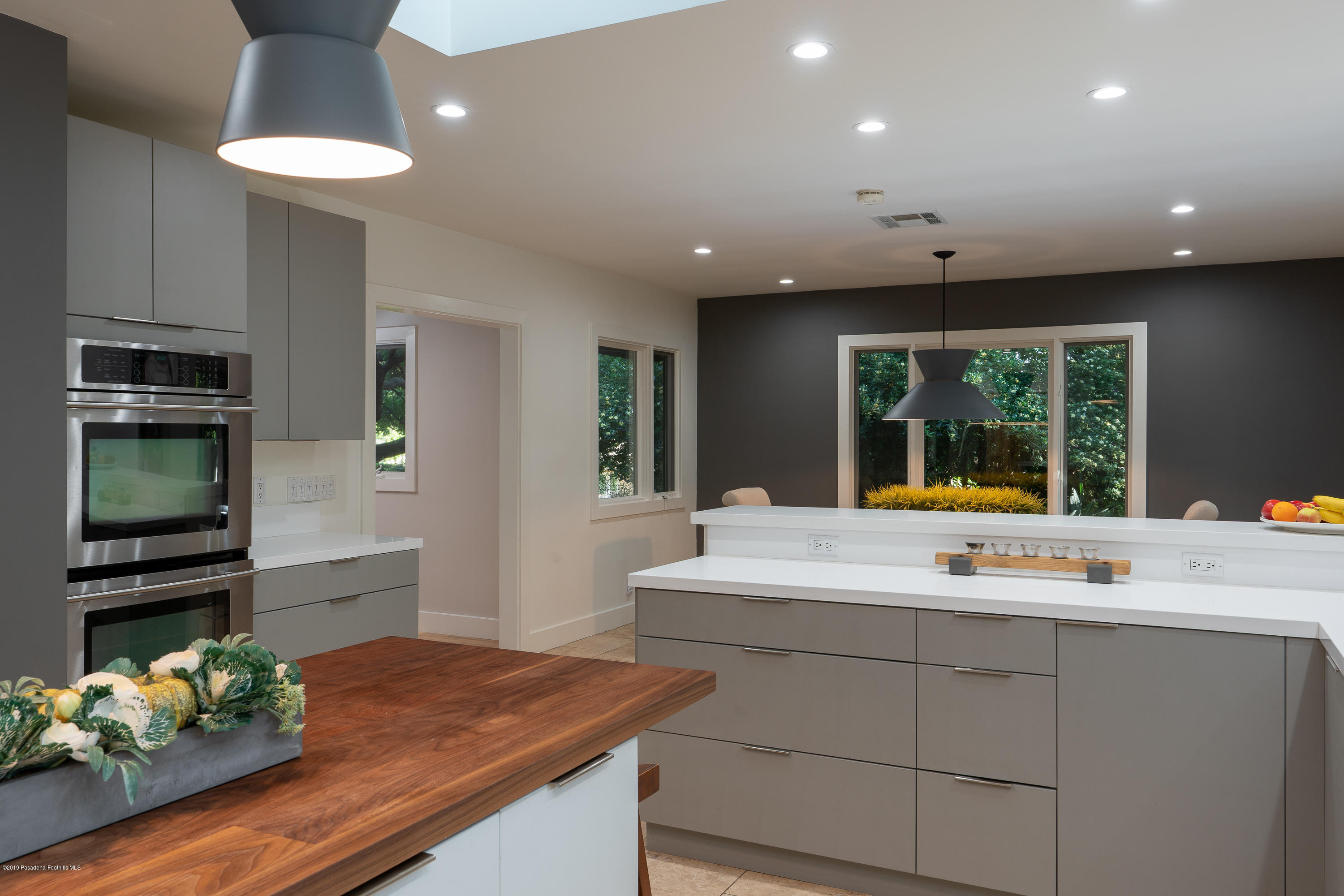 3795 Shadow Grove Road Pasadena, CA 91107 - Photo 14 of 48 a kitchen with kitchen island granite countertop a stove and a wooden floors