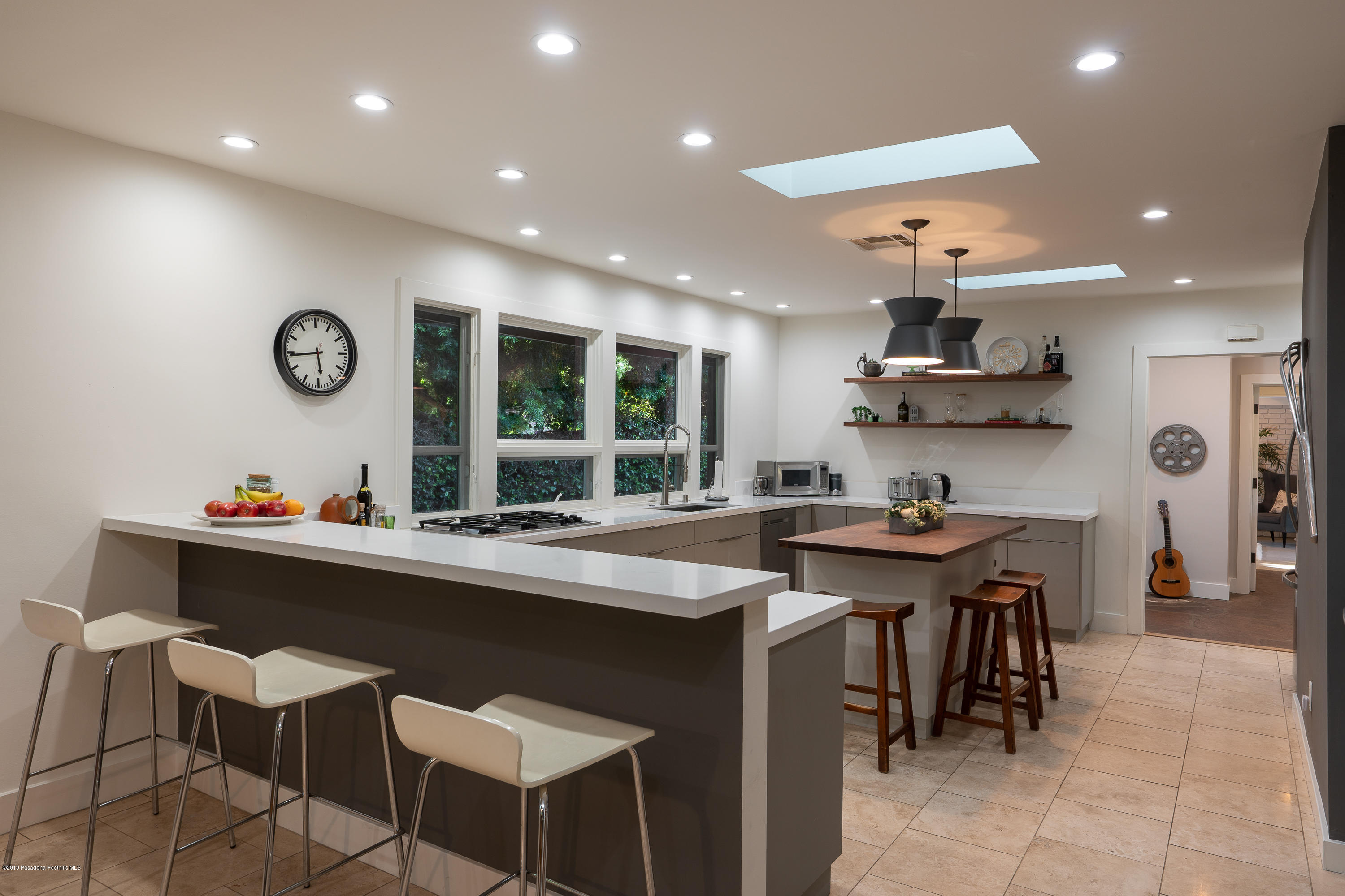 3795 Shadow Grove Road Pasadena, CA 91107 - Photo 15 of 48 a kitchen with stainless steel appliances kitchen island granite countertop a sink and a stove