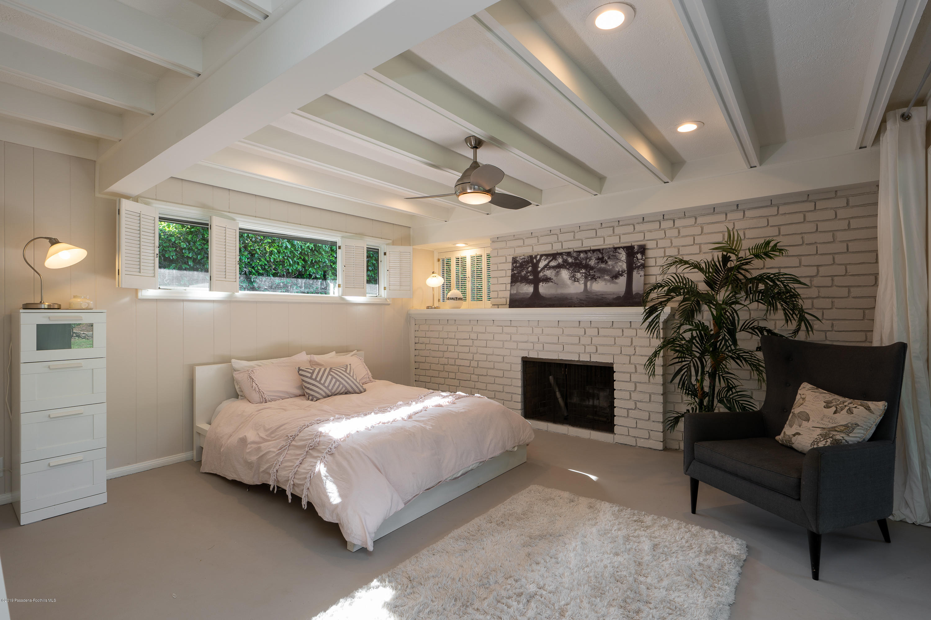 3795 Shadow Grove Road Pasadena, CA 91107 - Photo 19 of 48 a bedroom with furniture and a fireplace
