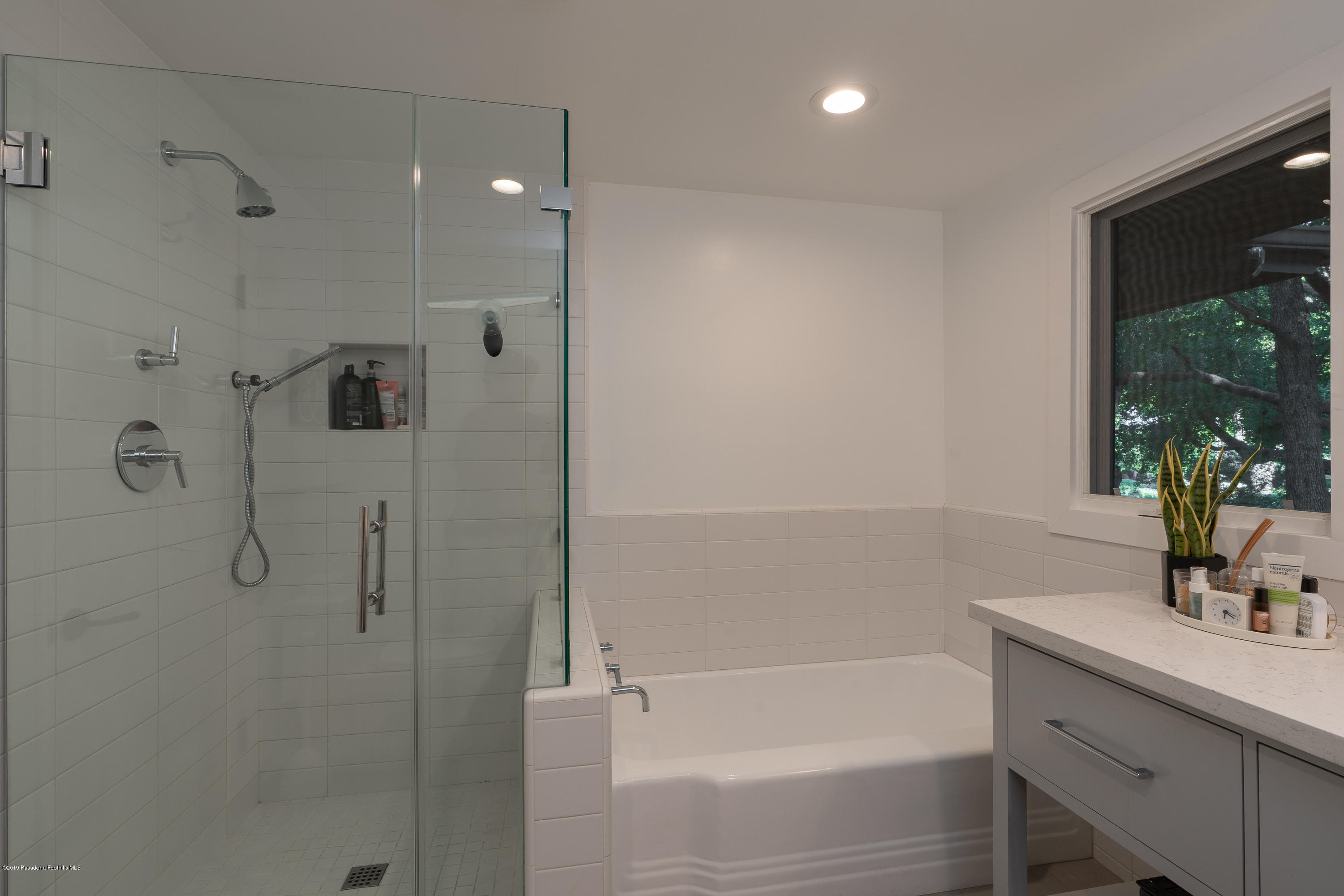 3795 Shadow Grove Road Pasadena, CA 91107 - Photo 29 of 48 a bathroom with a bathtub sink vanity and a shower