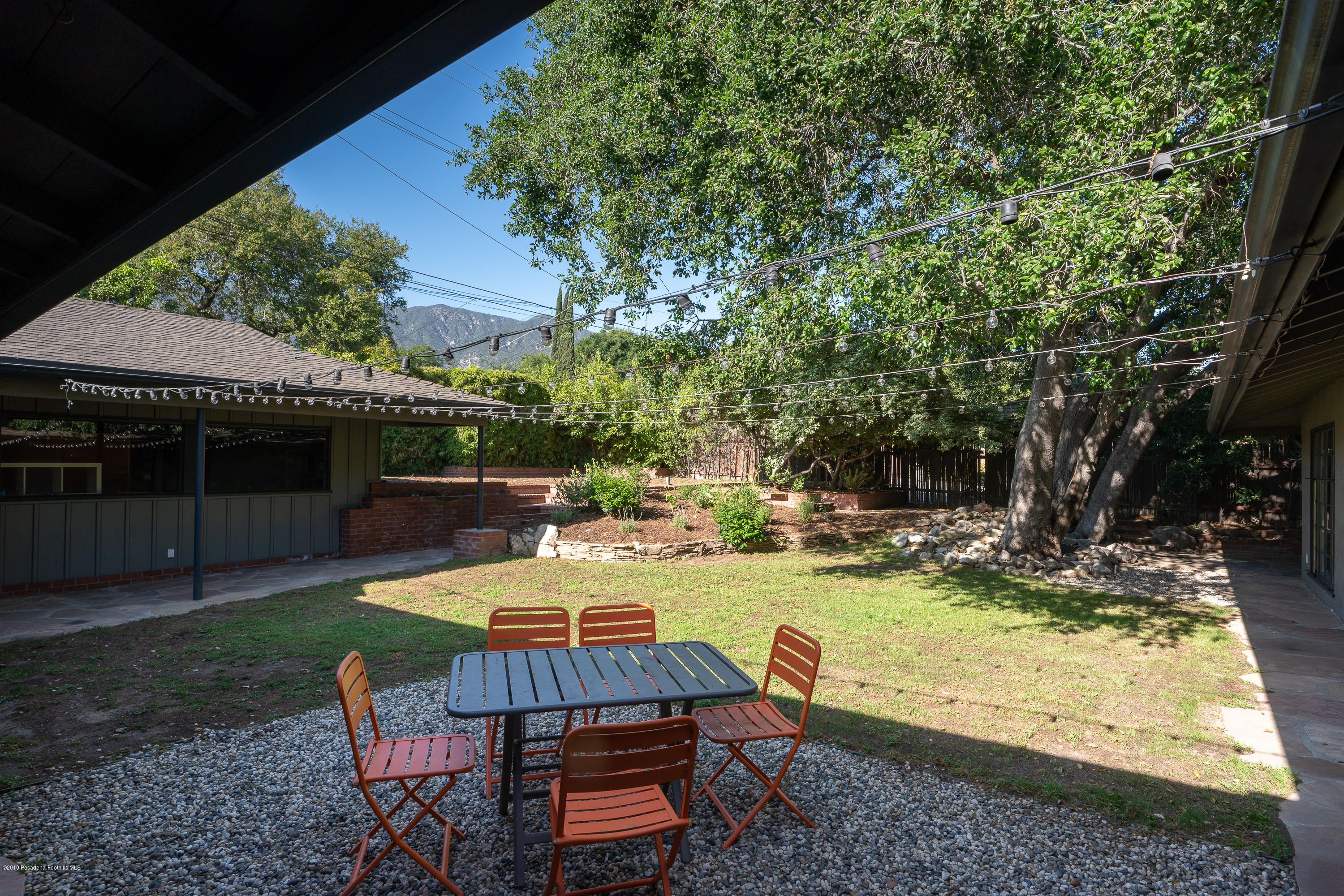 3795 Shadow Grove Road Pasadena, CA 91107 - Photo 30 of 48 a view of a swimming pool with chairs and a table