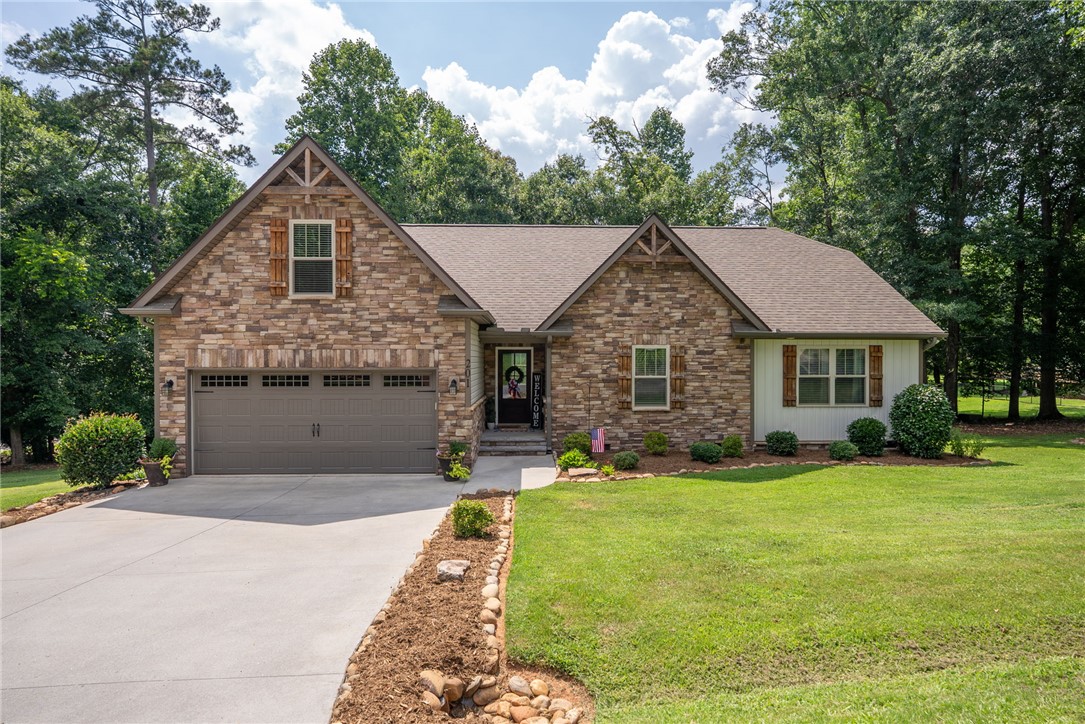 201 Hearthstone Drive Anderson, SC 29621 - Photo 41 of 49 A well-kept lawn and thoughtful landscaping enhance this charming stone and siding residence.