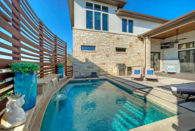a view of house with swimming pool outdoor seating
