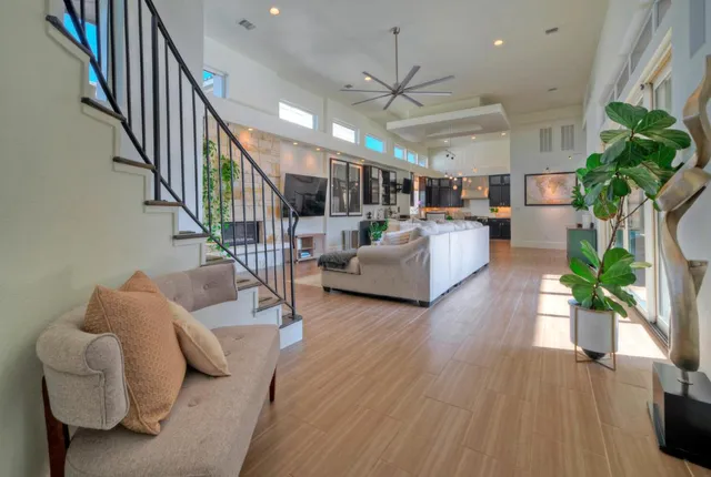 a living room with furniture and a chandelier