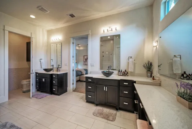 a spacious bathroom with a tub sink shower and mirror