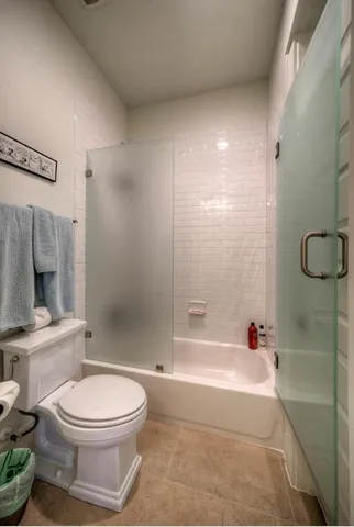 a bathroom with a toilet and a shower
