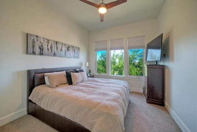 a bed sitting in a bedroom next to a window