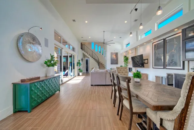 a dining room with furniture a rug and wooden floor