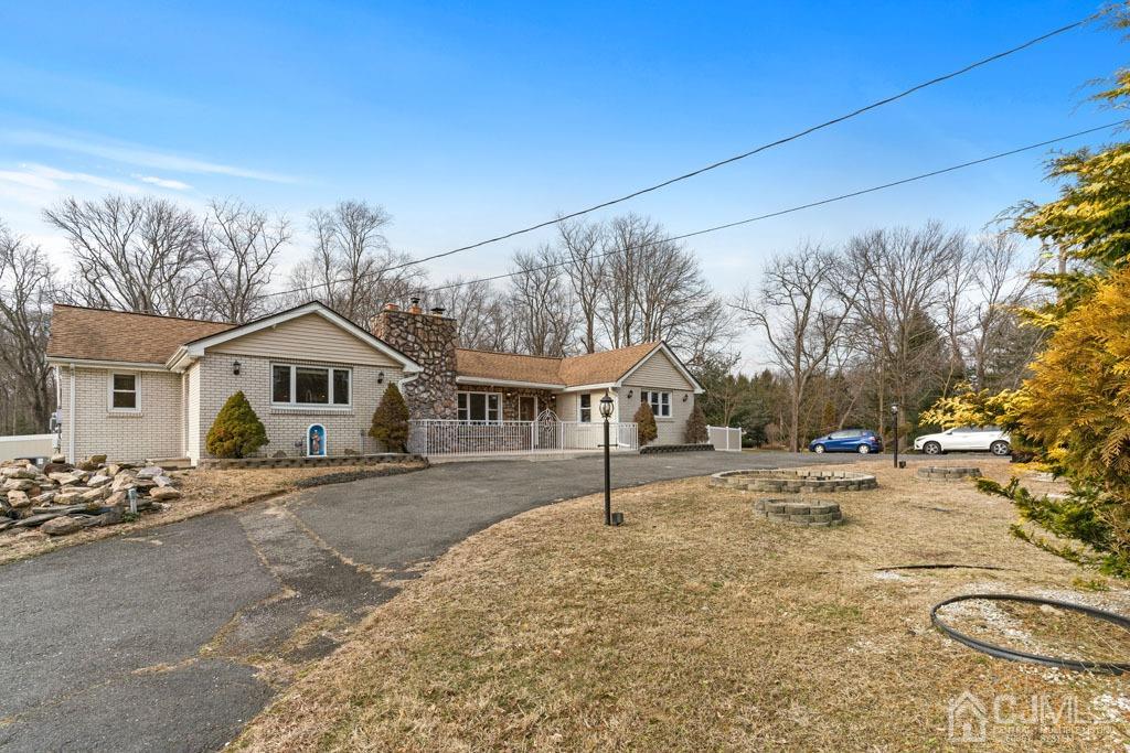 436 Tennent Road Morganville, NJ 07751 - Photo 2 of 36 Side view of house with large driveway