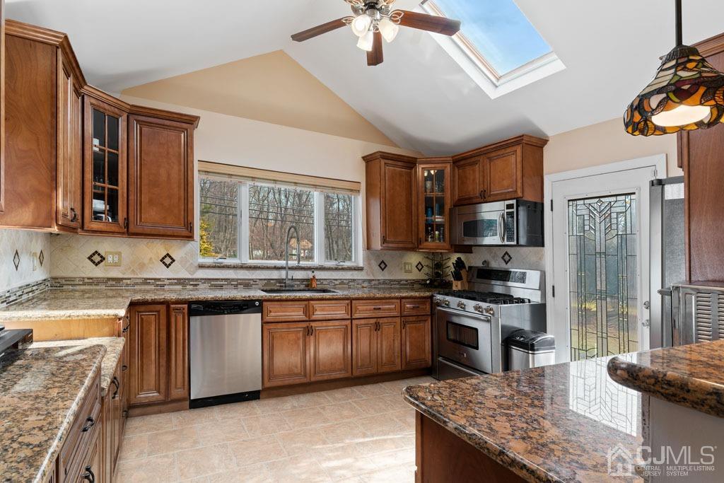 436 Tennent Road Morganville, NJ 07751 - Photo 12 of 36 Kitchen with granite counters, oversized window, sky-lights, ss appliances, and oversized sink