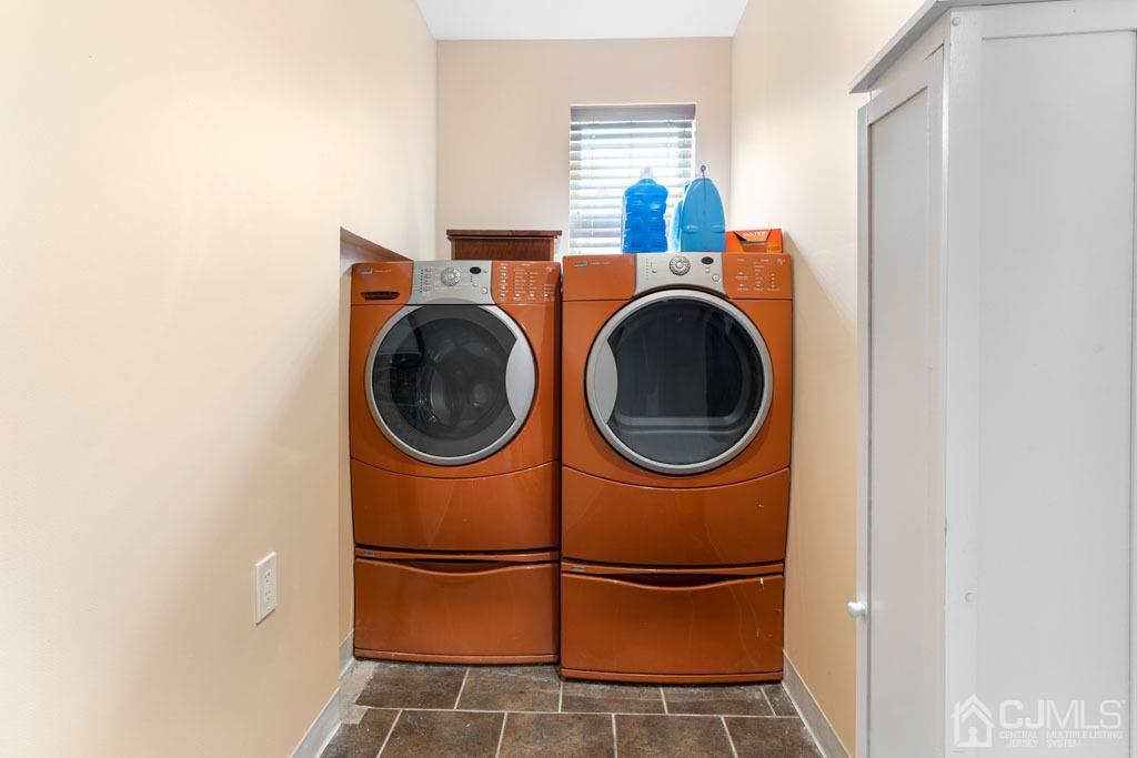 436 Tennent Road Morganville, NJ 07751 - Photo 26 of 36 Laundry room with shelving and sink