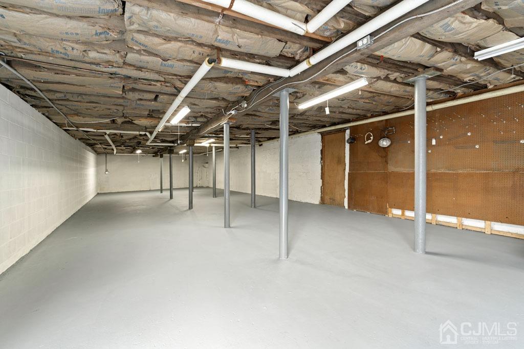 436 Tennent Road Morganville, NJ 07751 - Photo 27 of 36 Back half of basement with garage and walk out