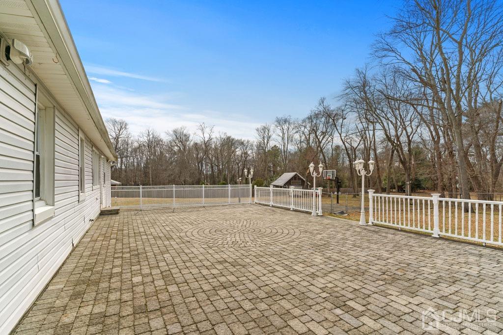 436 Tennent Road Morganville, NJ 07751 - Photo 31 of 36 Paver patio with lighting