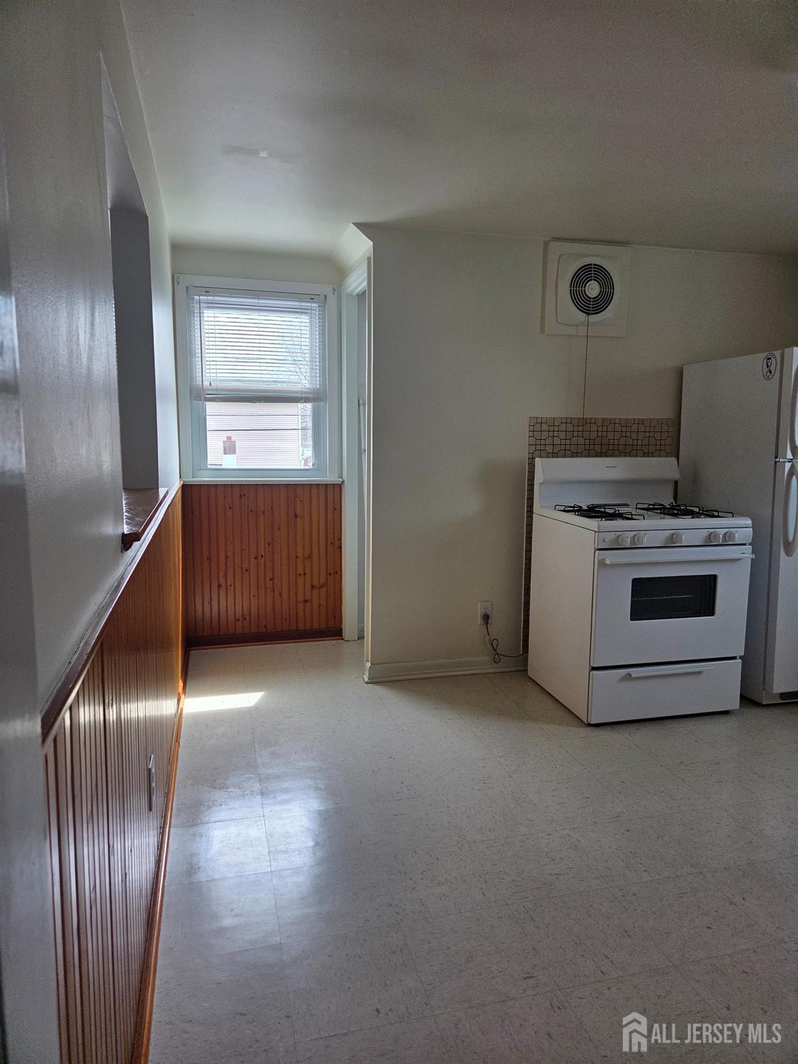 83 Daniel Street Port Reading, NJ 07064 - Photo 12 of 15 a kitchen with a refrigerator and a sink