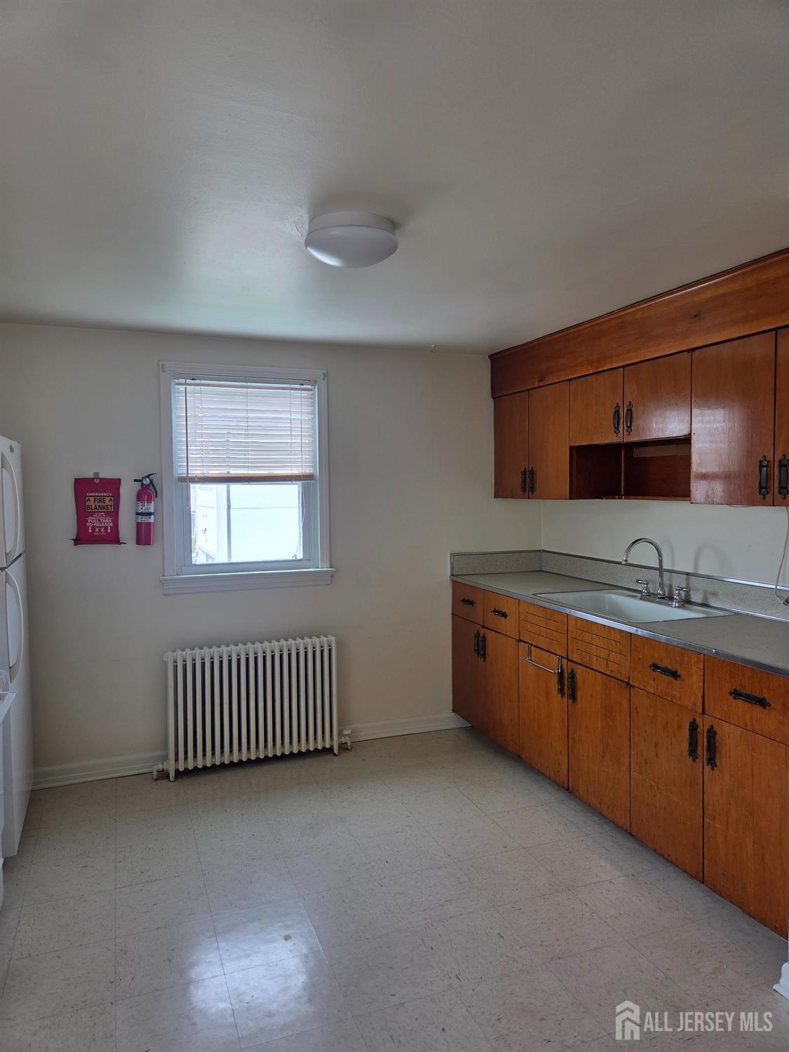 83 Daniel Street Port Reading, NJ 07064 - Photo 13 of 15 a spacious bathroom with a sink and a mirror
