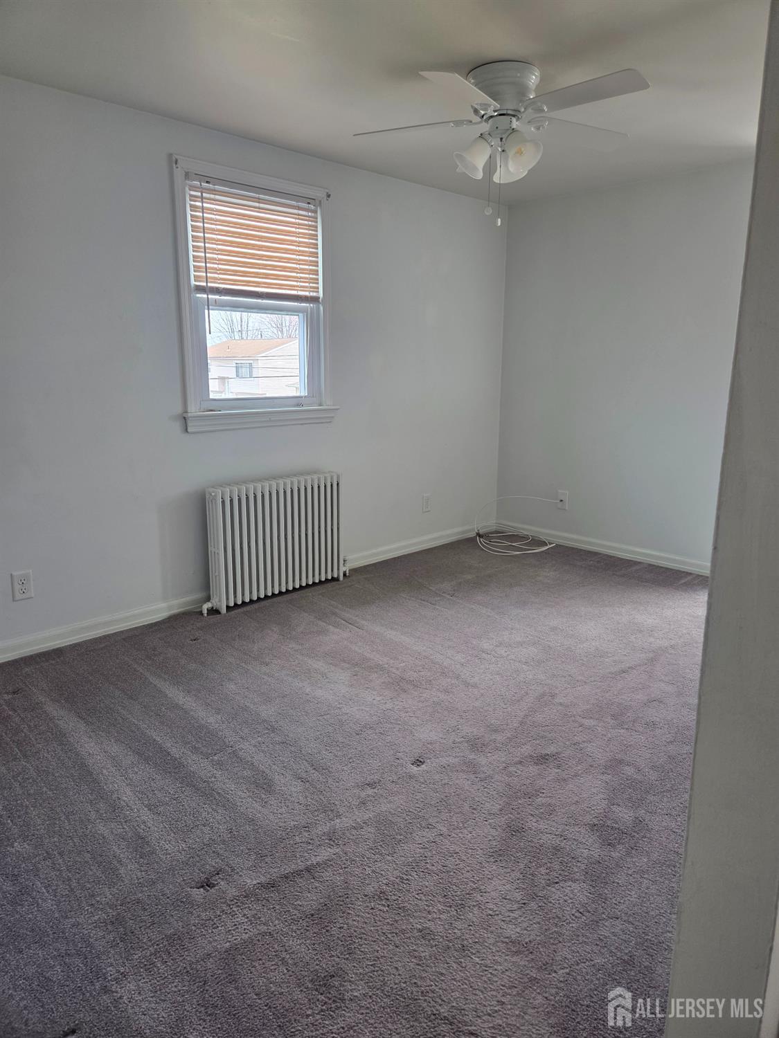 83 Daniel Street Port Reading, NJ 07064 - Photo 14 of 15 an empty room with windows