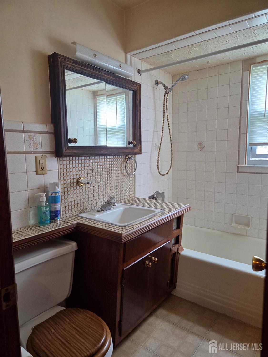 83 Daniel Street Port Reading, NJ 07064 - Photo 15 of 15 a bathroom with a granite countertop sink toilet and shower