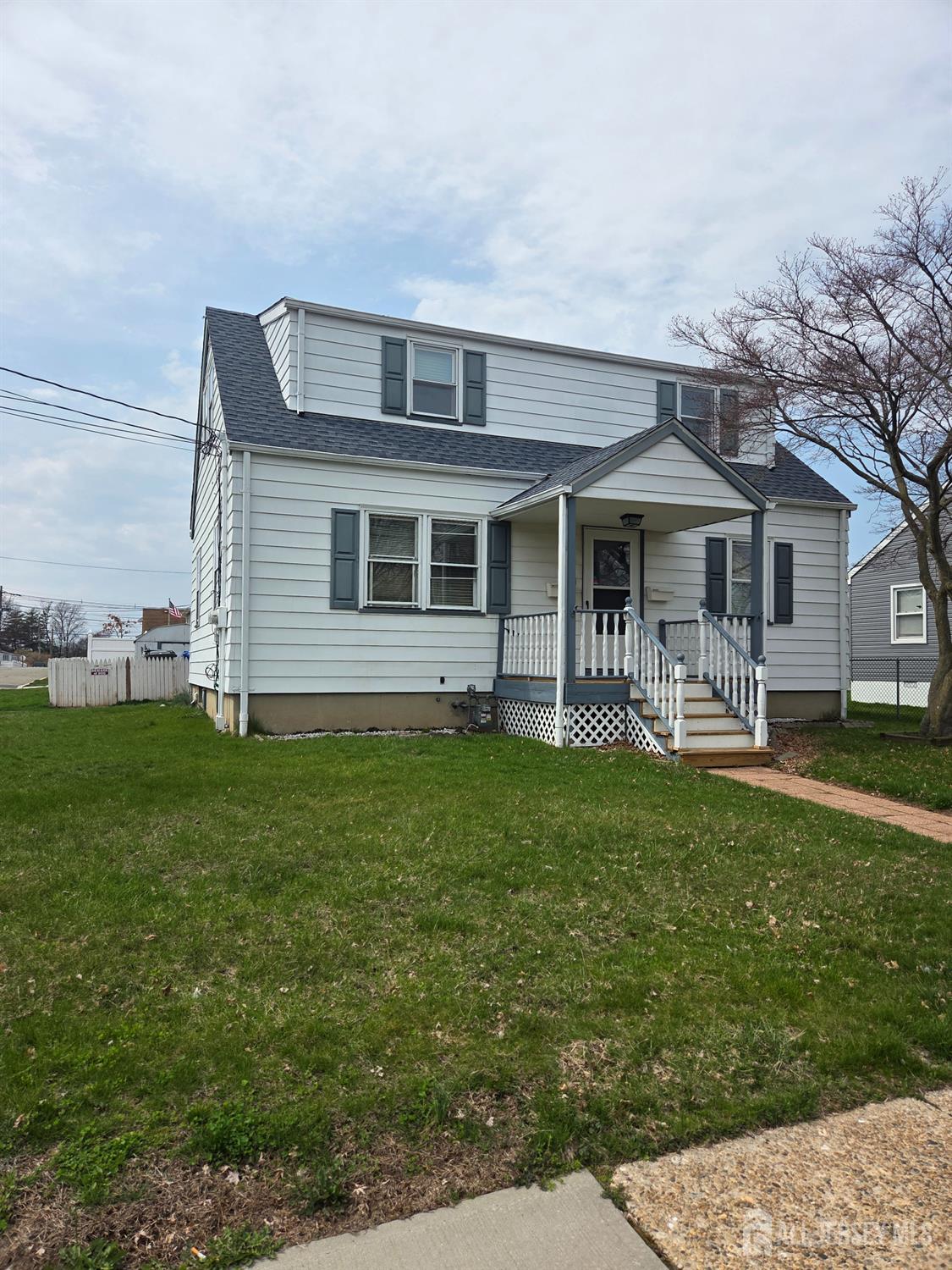 83 Daniel Street Port Reading, NJ 07064 - Photo 2 of 15 a front view of a house with a garden