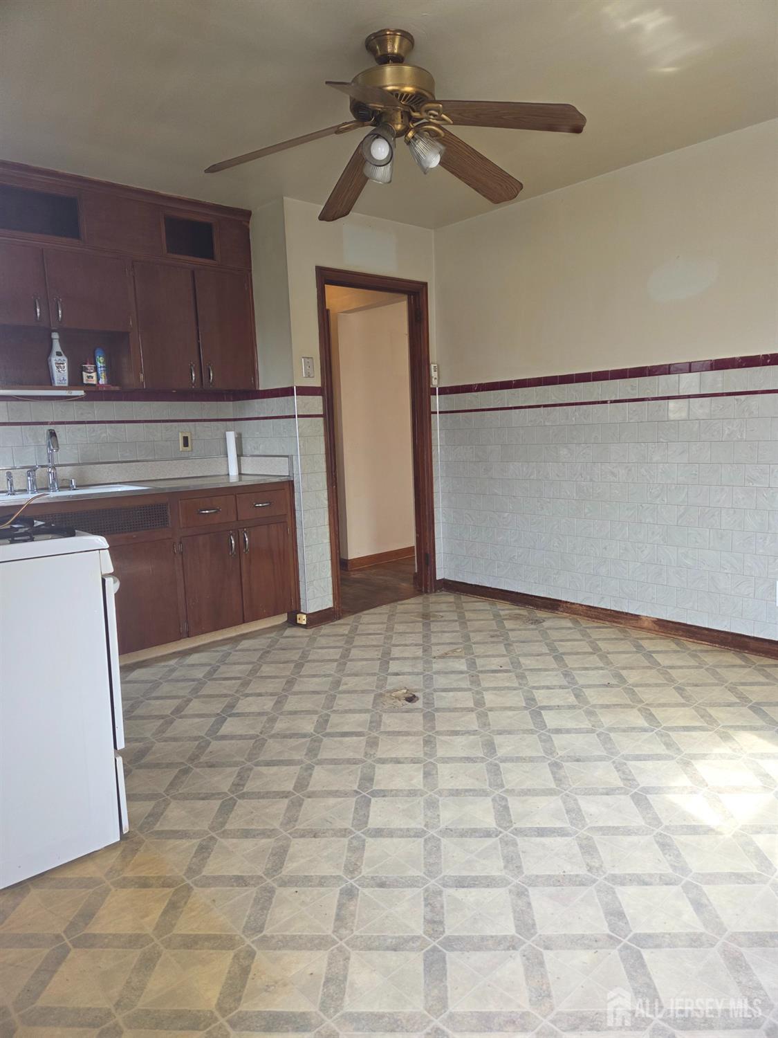 83 Daniel Street Port Reading, NJ 07064 - Photo 7 of 15 a view of a kitchen with a sink and cabinets