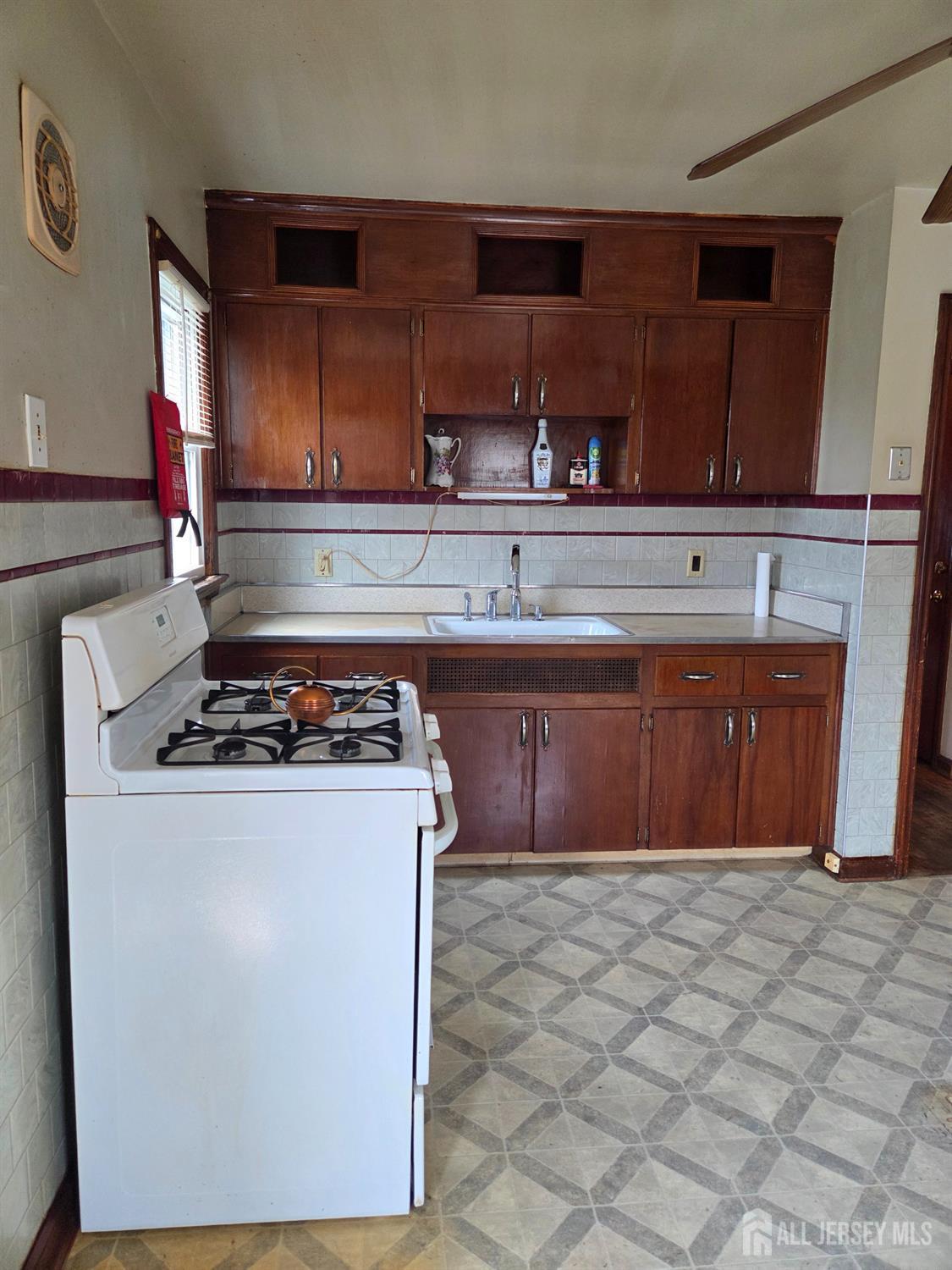 83 Daniel Street Port Reading, NJ 07064 - Photo 8 of 15 a kitchen with a stove top oven sink and cabinets
