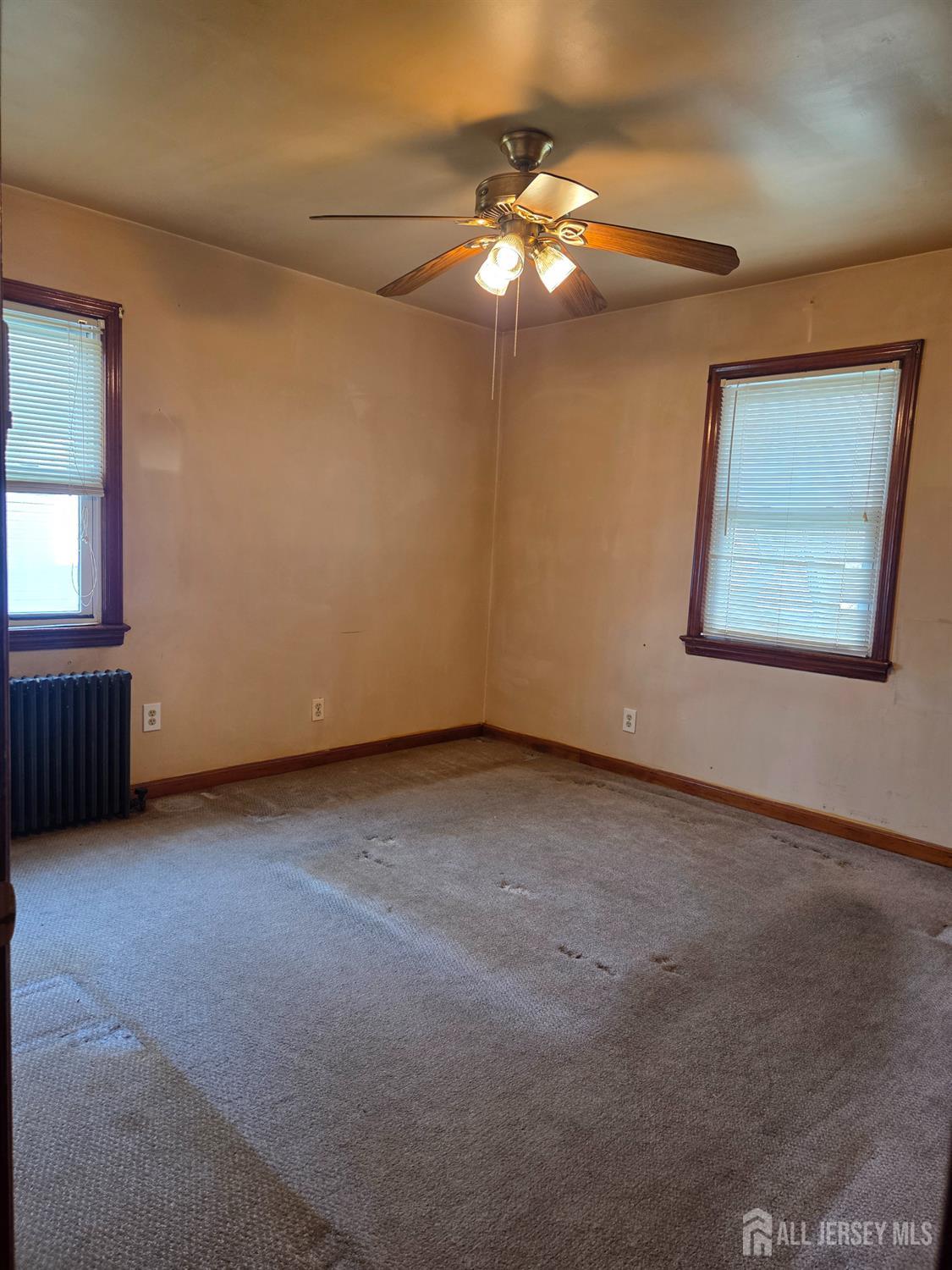 83 Daniel Street Port Reading, NJ 07064 - Photo 9 of 15 an empty room with a chandelier fan