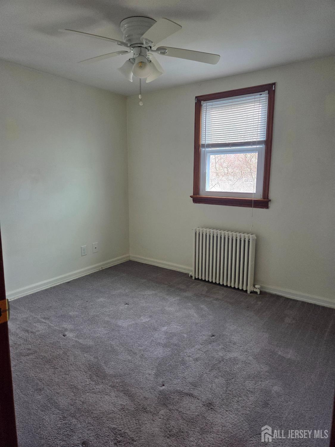 83 Daniel Street Port Reading, NJ 07064 - Photo 10 of 15 an empty room with windows