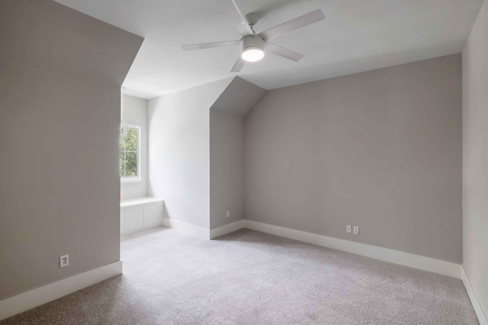 5512 Ballenton Lane Austin, TX 78739 - Photo 28 of 40 A well-lit bedroom features sloped ceilings and a window seat with built-in storage.