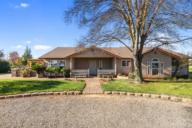 a front view of a house with garden and porch