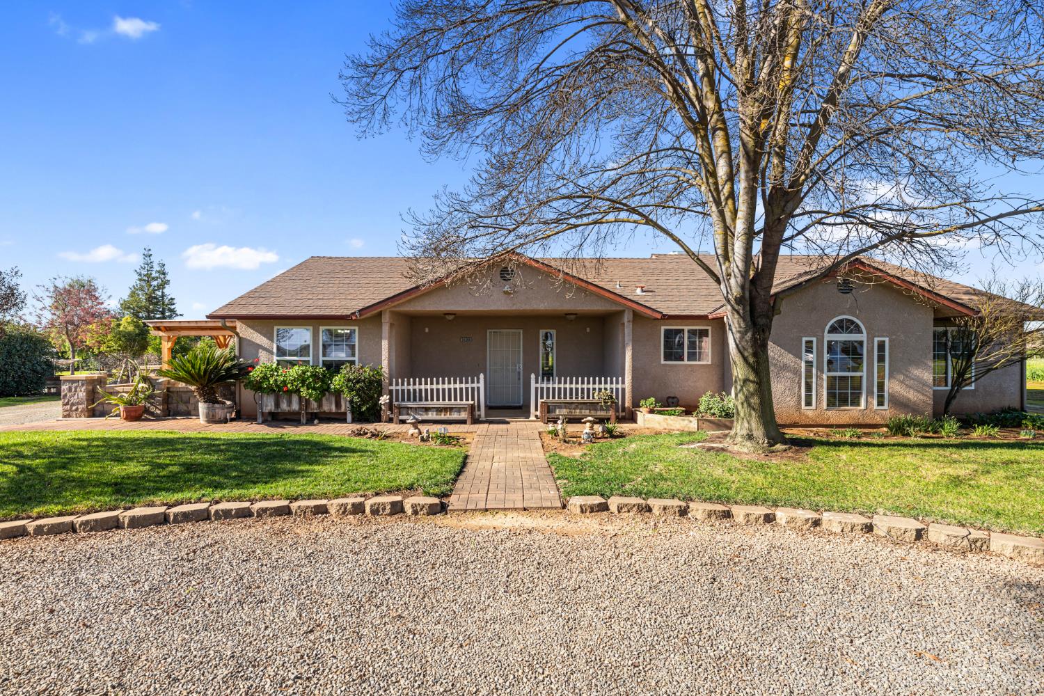 14304 Huntington Road Madera, CA 93636 - Photo 1 of 33 a front view of a house with garden and porch