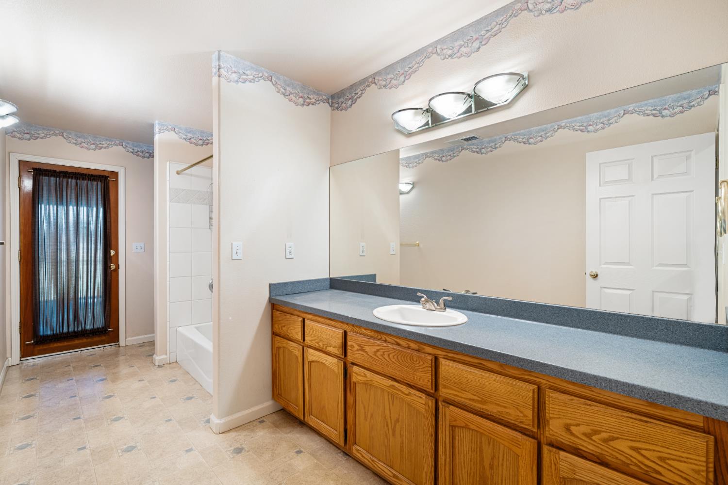 14304 Huntington Road Madera, CA 93636 - Photo 12 of 33 a bathroom with a sink and a mirror