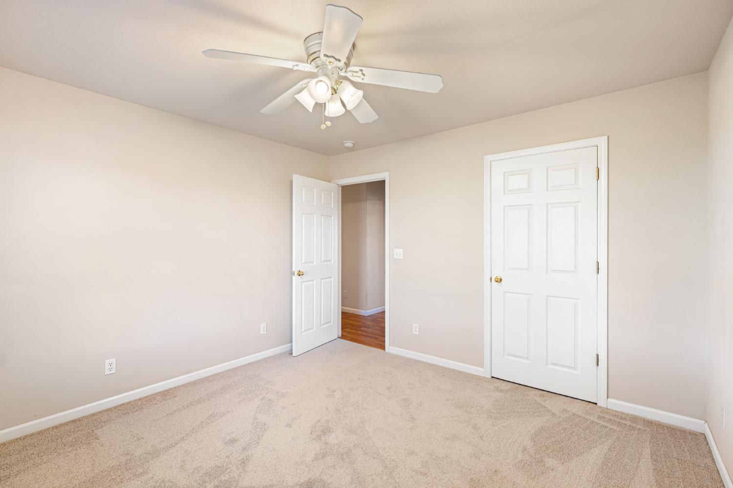 14304 Huntington Road Madera, CA 93636 - Photo 18 of 33 an empty room with a chandelier fan and closet
