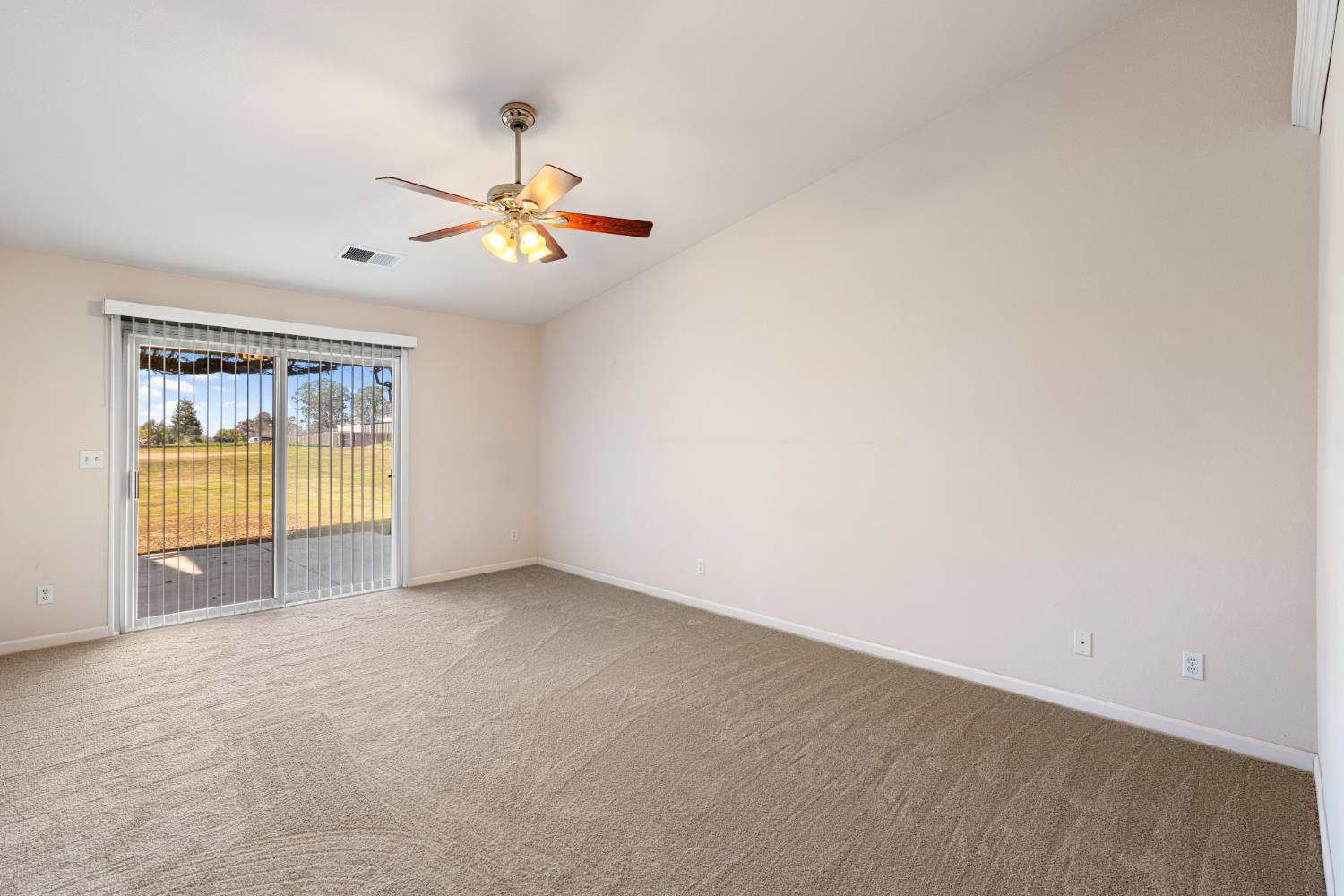 14304 Huntington Road Madera, CA 93636 - Photo 20 of 33 an empty room with a window and ceiling fan