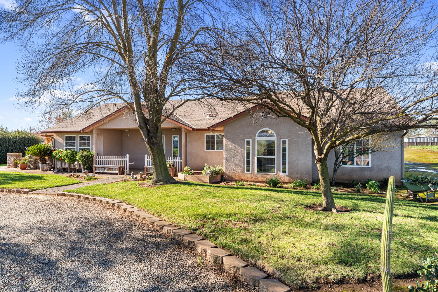 14304 Huntington Road Madera, CA 93636 - Photo 3 of 33 a view of a house with a yard and fence