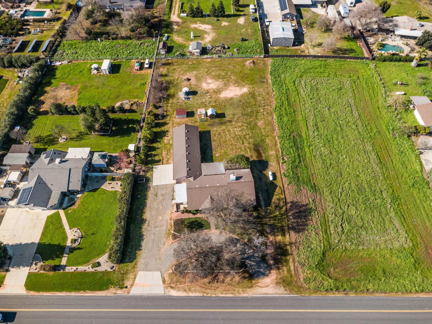 14304 Huntington Road Madera, CA 93636 - Photo 31 of 33 an aerial view of a residential houses with outdoor space and street view