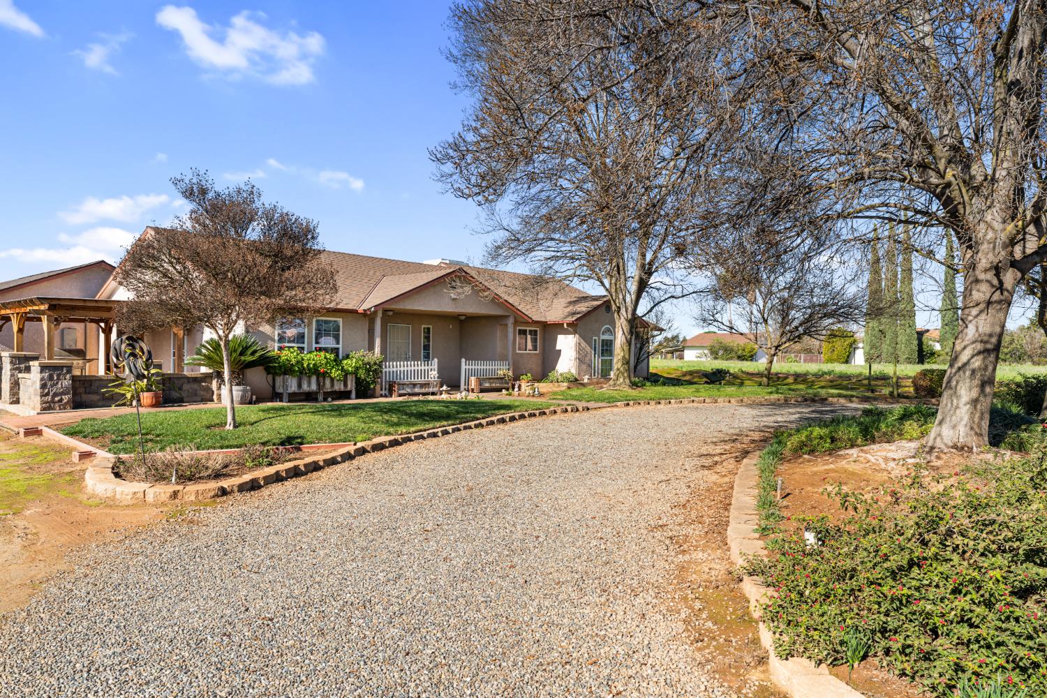 14304 Huntington Road Madera, CA 93636 - Photo 4 of 33 a view of road with large trees