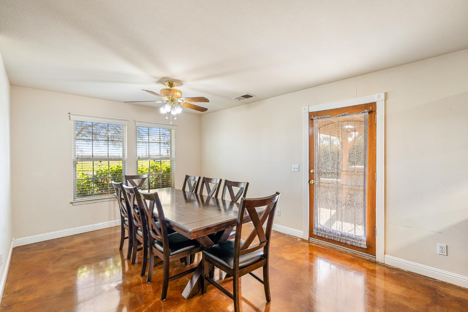 14304 Huntington Road Madera, CA 93636 - Photo 10 of 33 a view of a dining room with furniture and a window