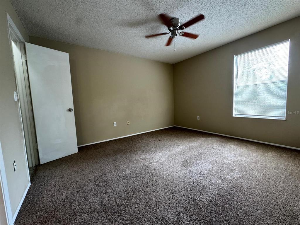 956 Salt Pond Place, Unit 205 Altamonte Springs, FL 32714 - Photo 11 of 15 an empty room with windows and fan