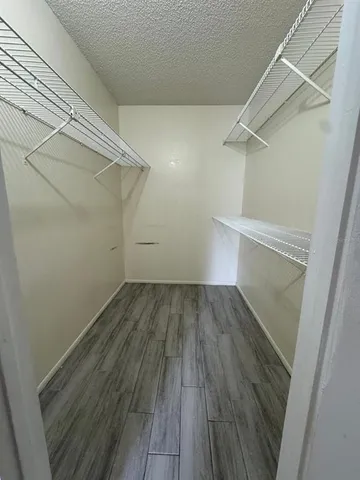 a view of a room with wooden floor