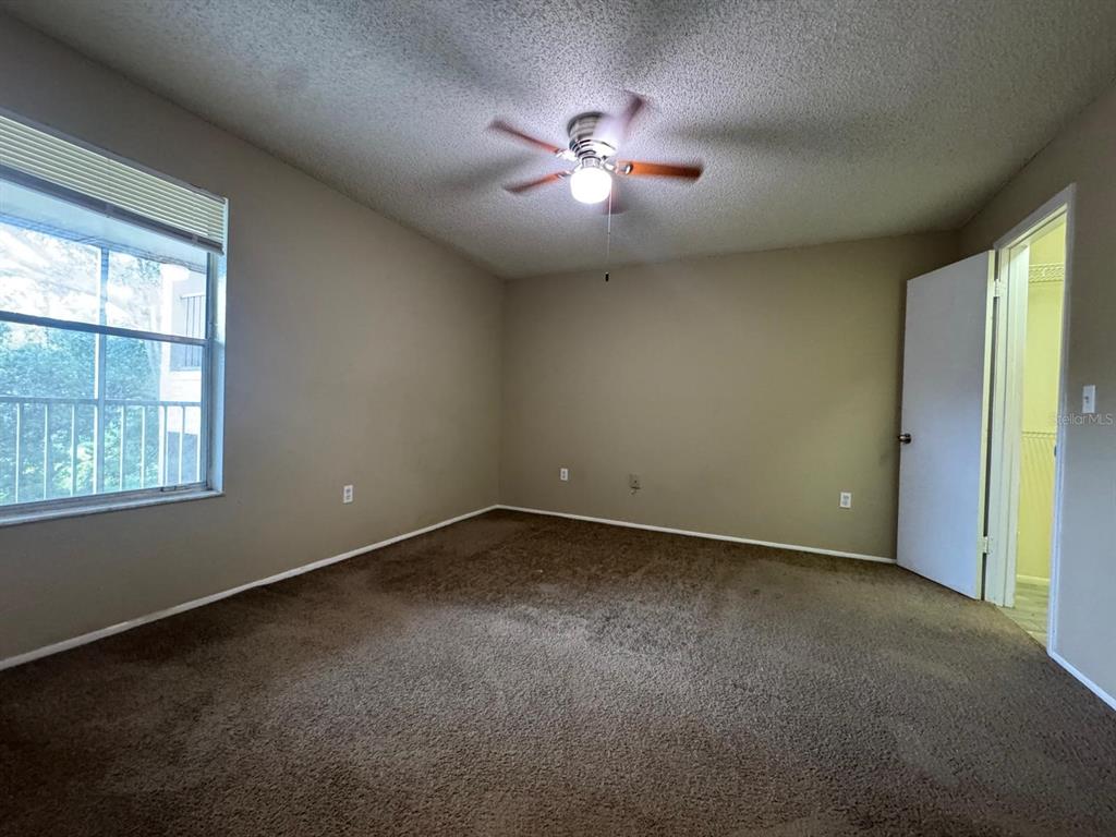 956 Salt Pond Place, Unit 205 Altamonte Springs, FL 32714 - Photo 7 of 15 an empty room with windows and chandelier fan