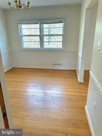 a view of a room with wooden floor and window