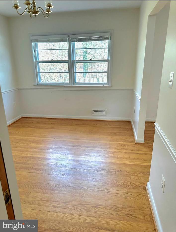6426 Noble Drive McLean, VA 22101 - Photo 6 of 16 a view of an empty room with wooden floor and a window